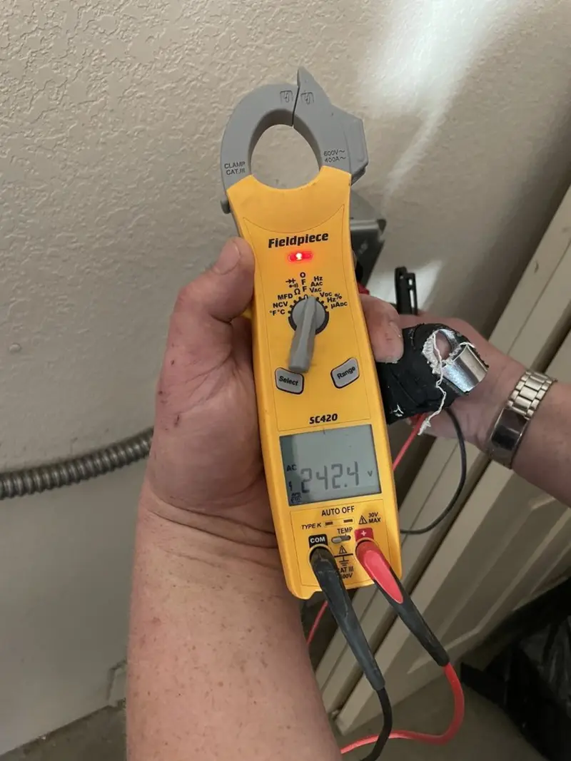 Voltage testing with clamp meter during Outlet Installation in Cicero